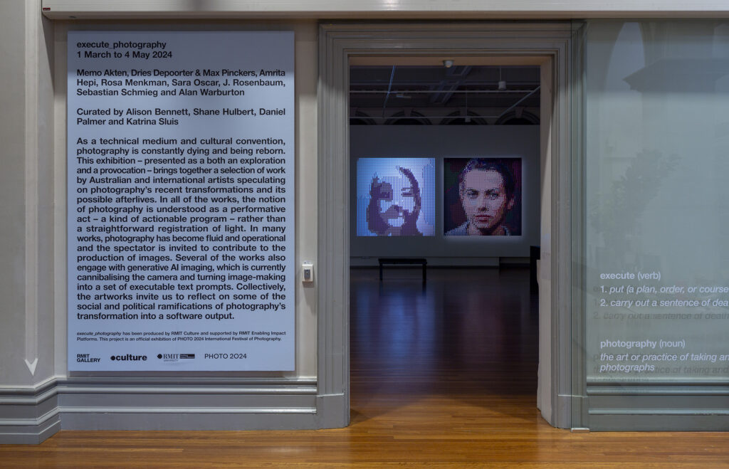 the entrance to RMIT Gallery with a large board about the exhibition and artists and gender tapestry visible in the background through the door.