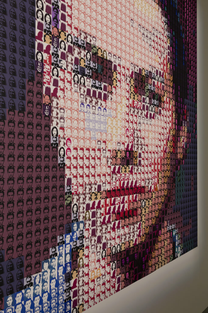 The wallpaper for gender tapestry on an angle. it is a gender neutral face made up of mini faces in different colors